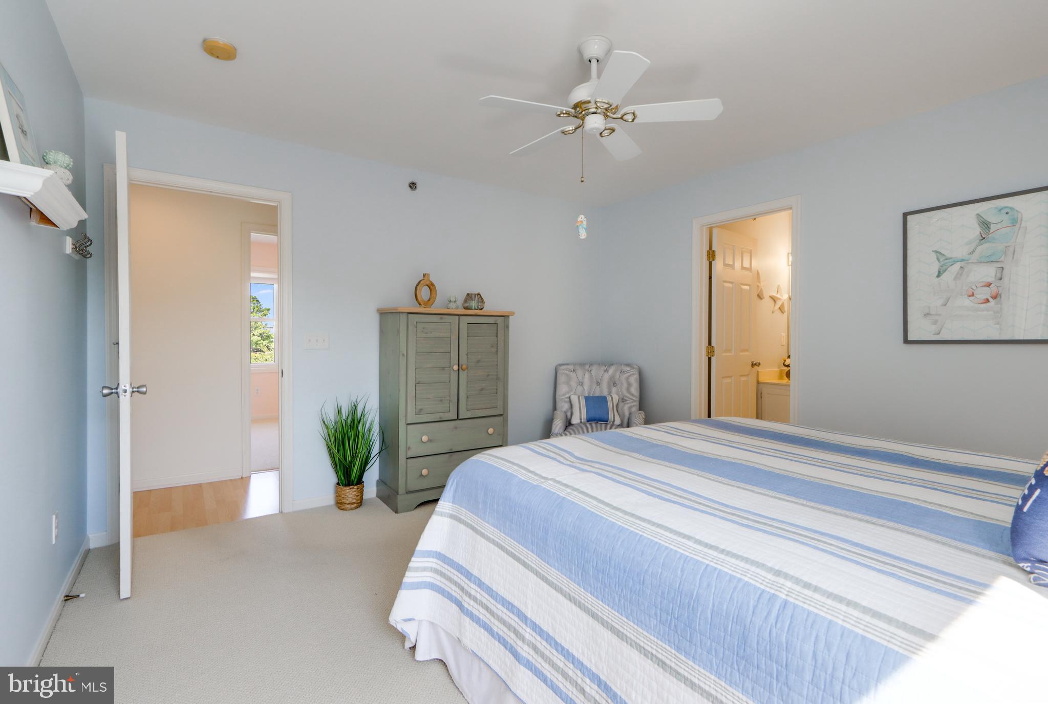 24 Brooklyn Avenue, Unit E Rehoboth Beach, DE 19971 - Photo 45 of 74 a bedroom with a bed and chandelier