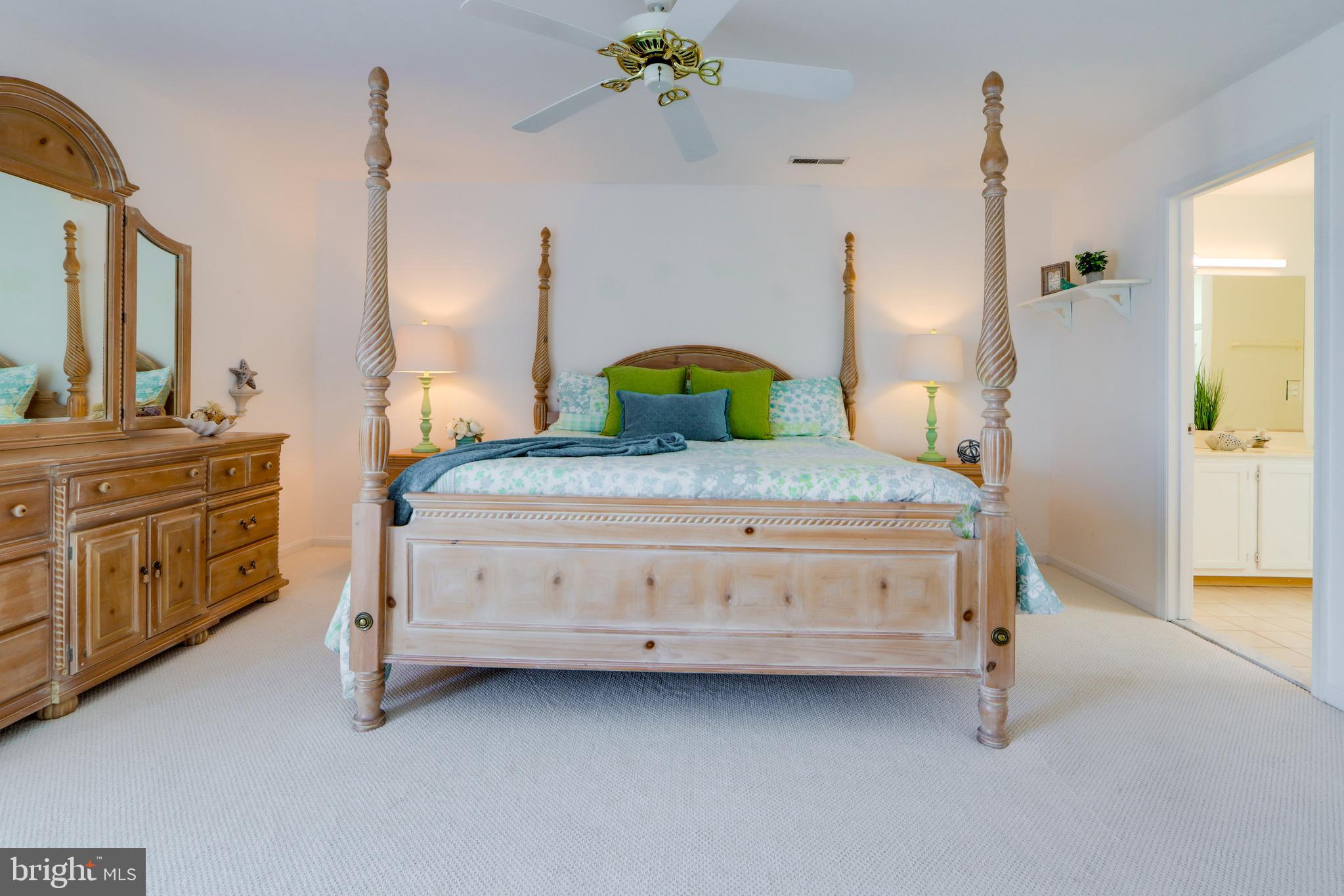 24 Brooklyn Avenue, Unit E Rehoboth Beach, DE 19971 - Photo 46 of 74 a bedroom with a bed and a dresser