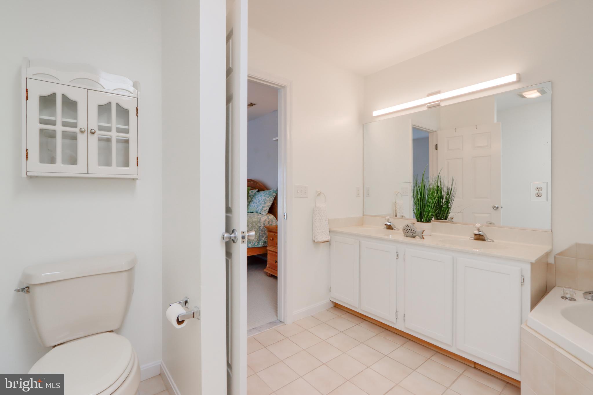 24 Brooklyn Avenue, Unit E Rehoboth Beach, DE 19971 - Photo 52 of 74 a bathroom with a sink a toilet and shower