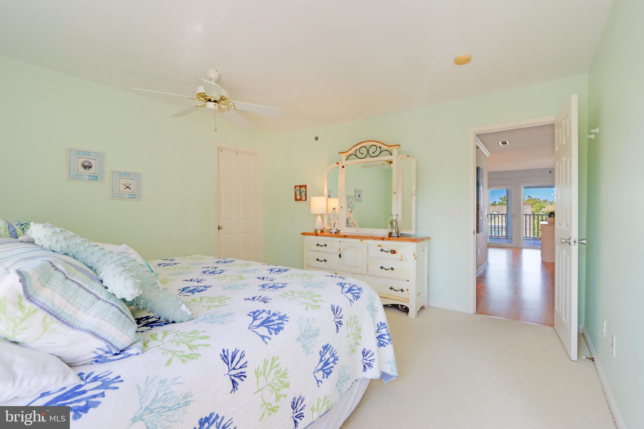 24 Brooklyn Avenue, Unit E Rehoboth Beach, DE 19971 - Photo 59 of 74 a bedroom with a bed and a mirror