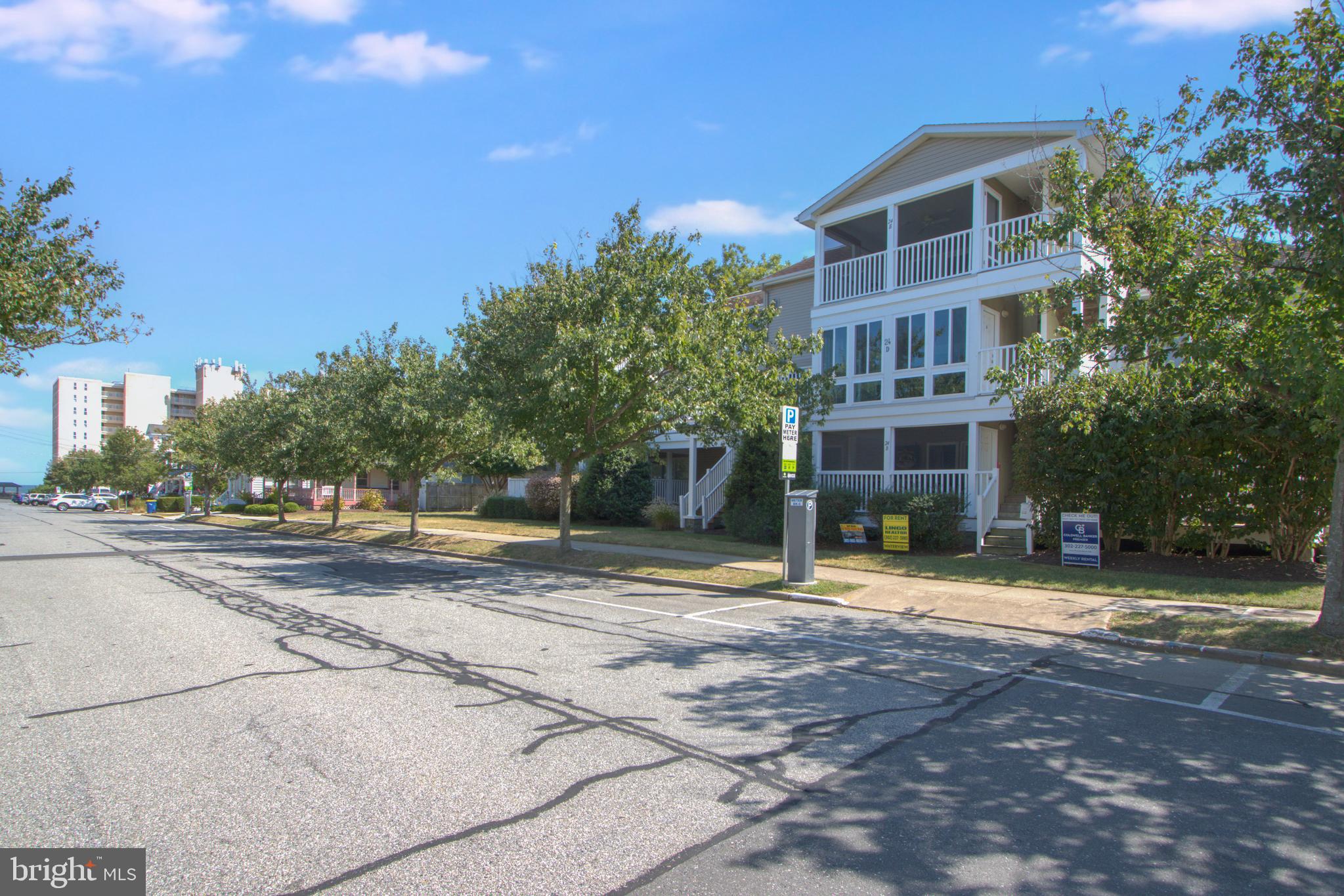 24 Brooklyn Avenue, Unit E Rehoboth Beach, DE 19971 - Photo 62 of 74 a view of a brick building next to a yard