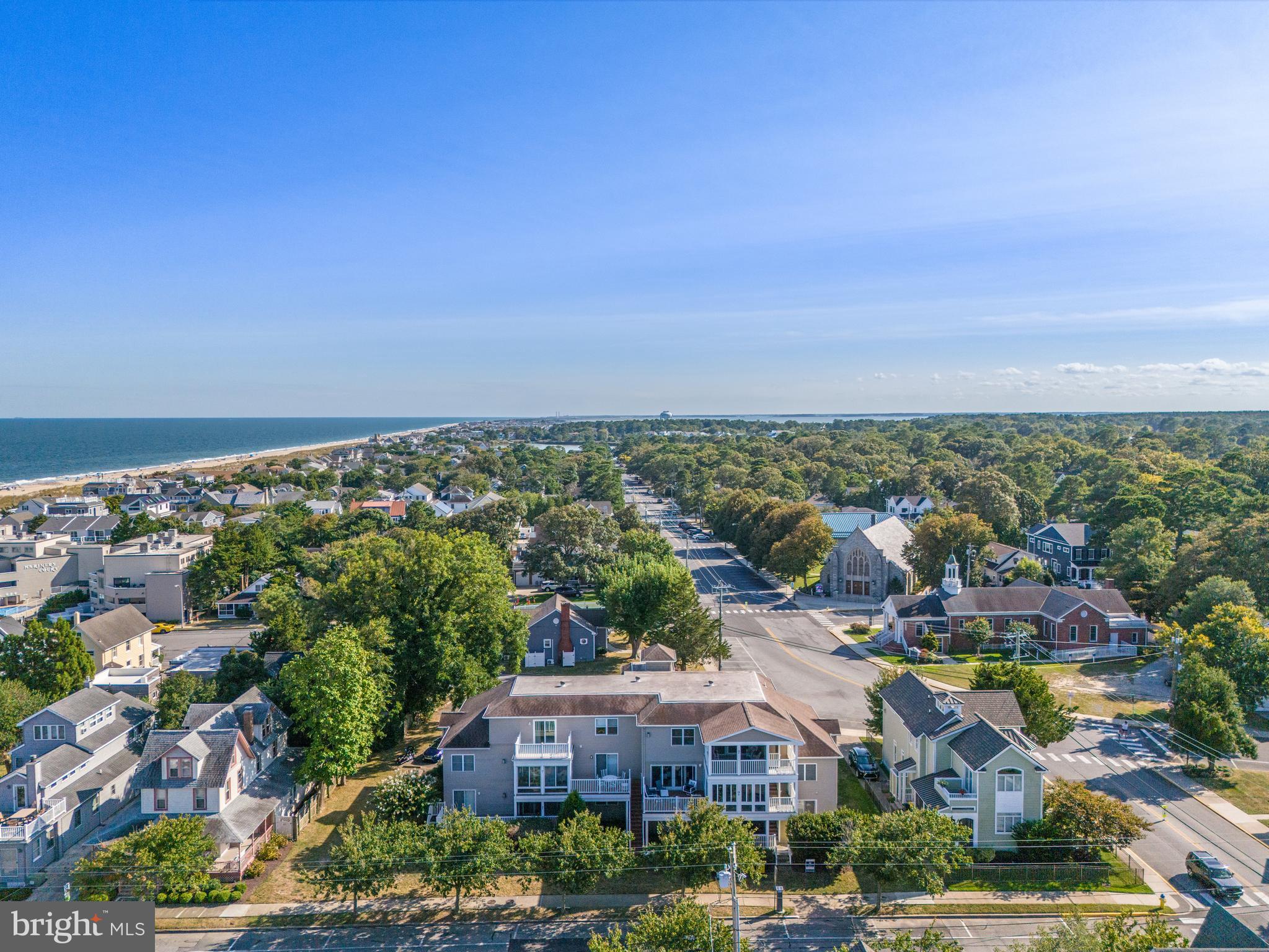 24 Brooklyn Avenue, Unit E Rehoboth Beach, DE 19971 - Photo 72 of 74 an aerial view of residential houses with outdoor space and trees