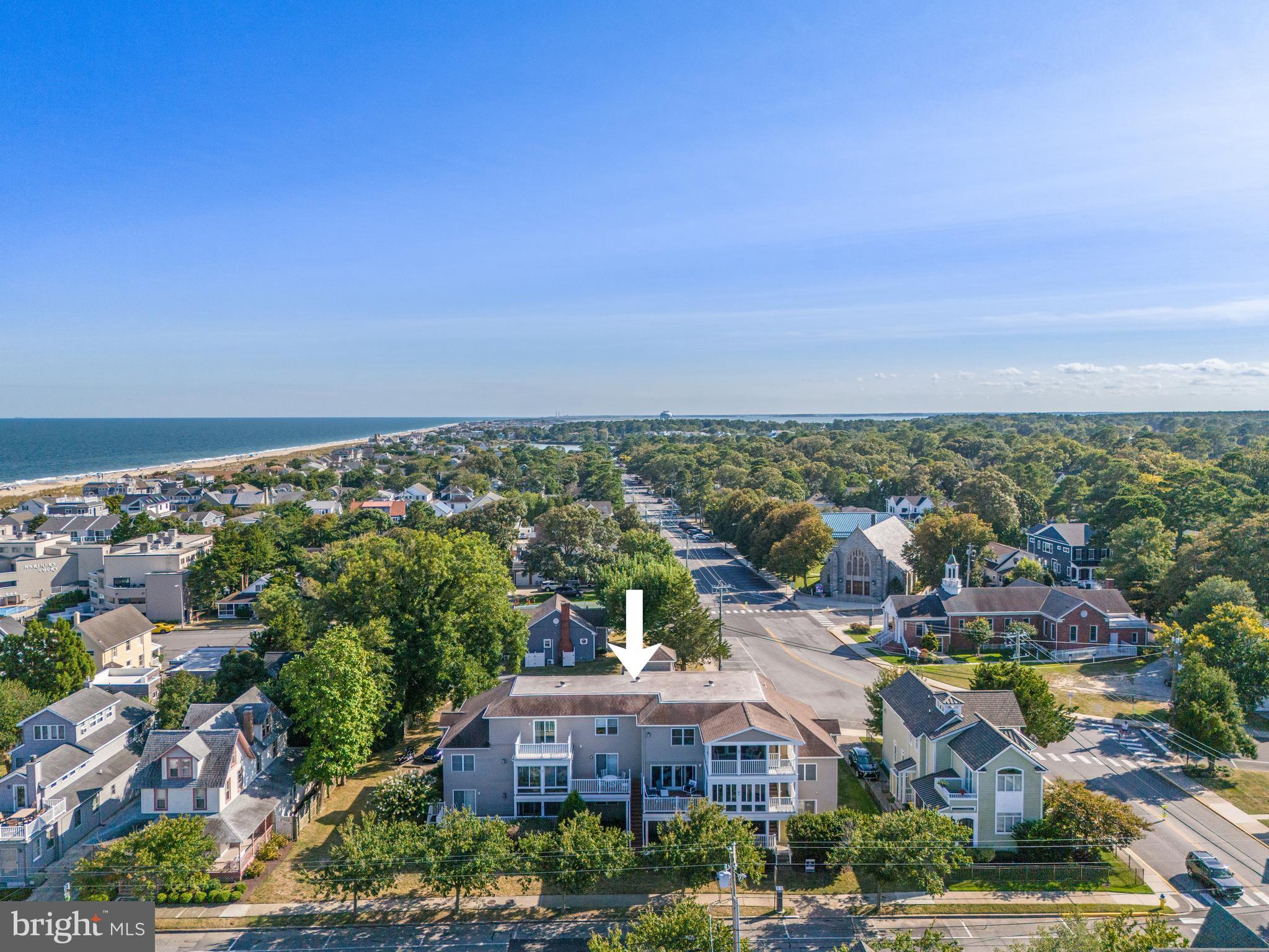 24 Brooklyn Avenue, Unit E Rehoboth Beach, DE 19971 - Photo 73 of 74 an aerial view of residential houses with outdoor space and trees