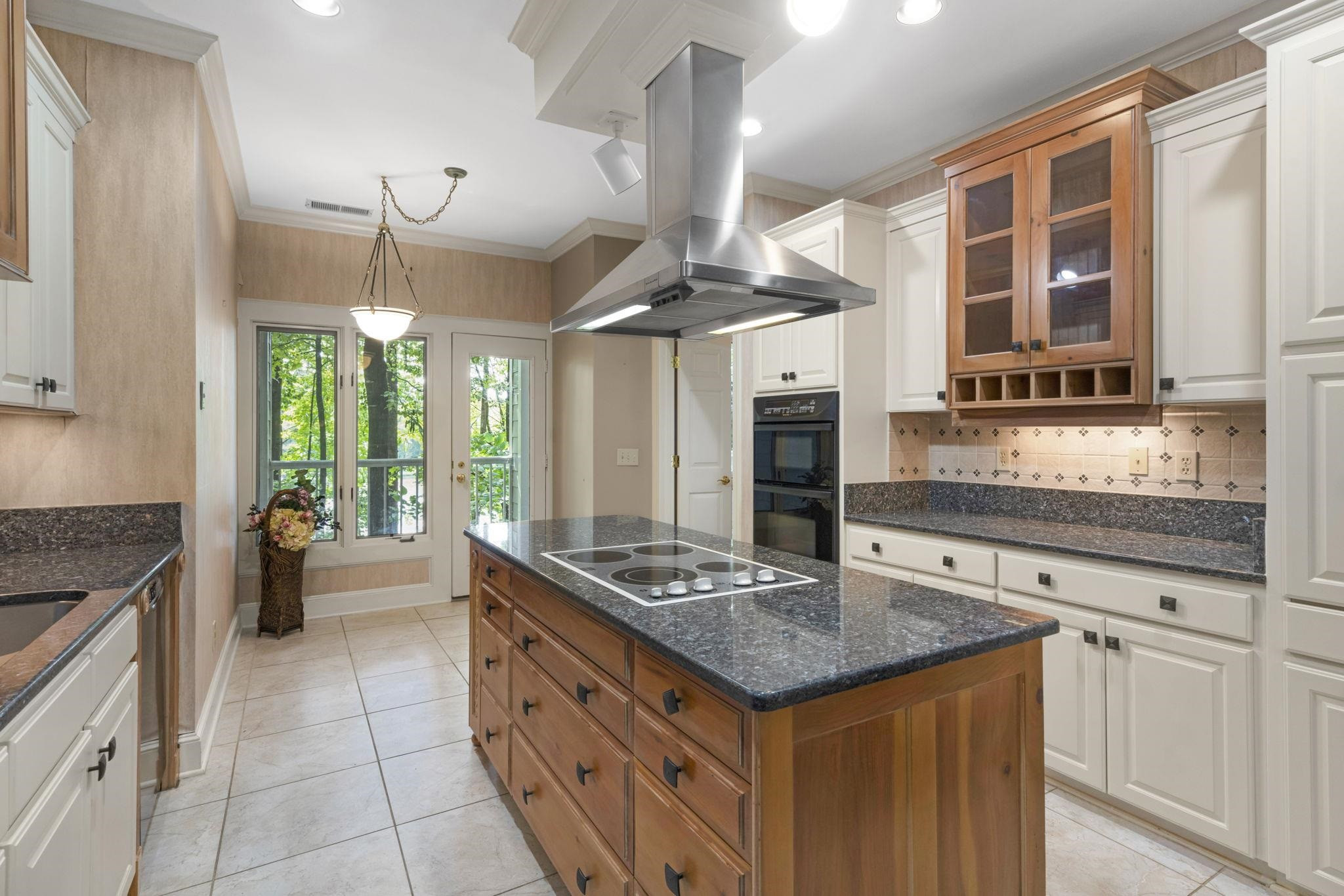 7500 Dartford Court, Unit 102 Raleigh, NC 27615 - Photo 13 of 36 a kitchen with granite countertop a sink stove and cabinets