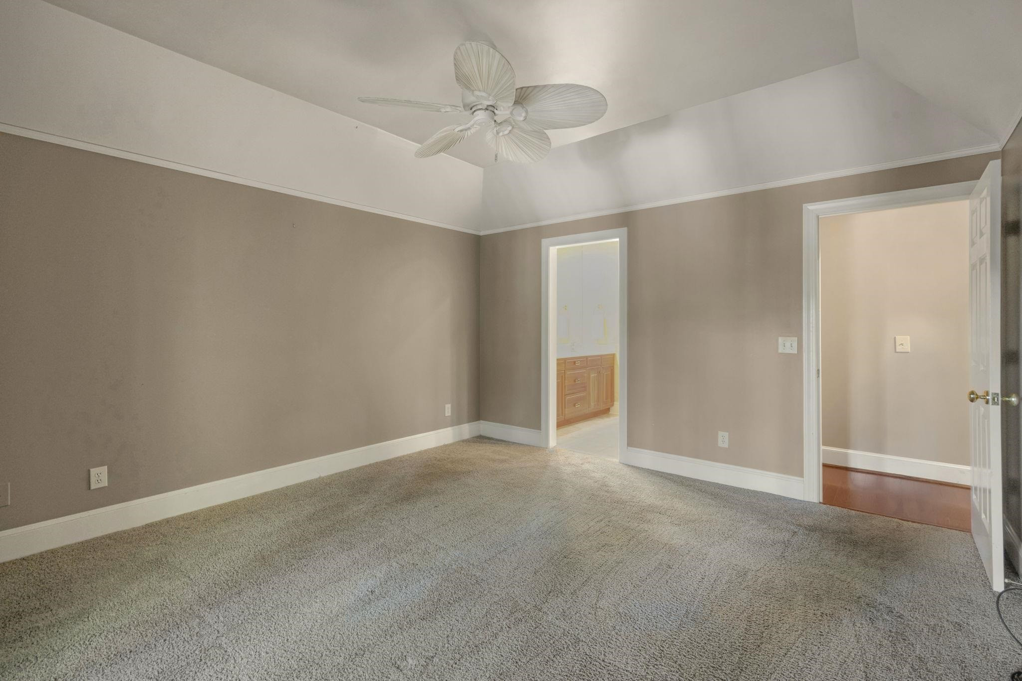 7500 Dartford Court, Unit 102 Raleigh, NC 27615 - Photo 16 of 36 an empty room with a ceiling fan and a window