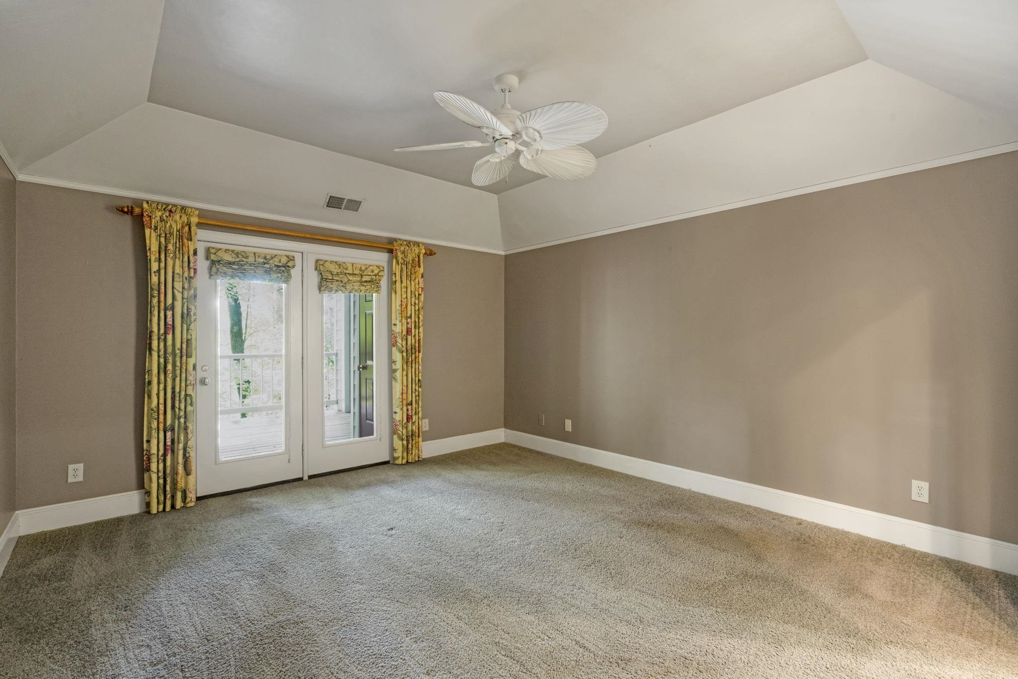 7500 Dartford Court, Unit 102 Raleigh, NC 27615 - Photo 18 of 36 an empty room with a ceiling fan and a window