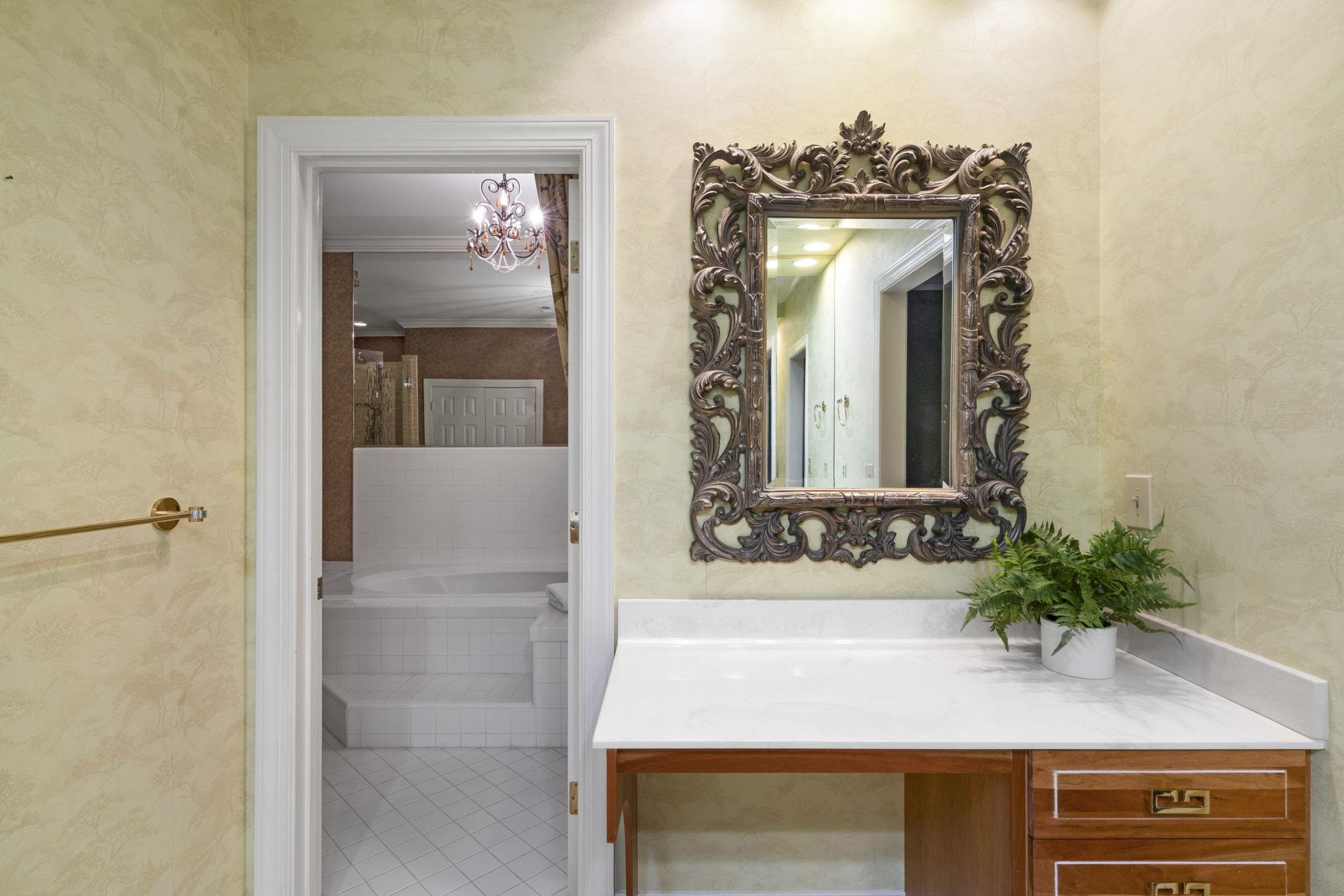 7500 Dartford Court, Unit 102 Raleigh, NC 27615 - Photo 20 of 36 a bathroom with a sink a mirror and a shower