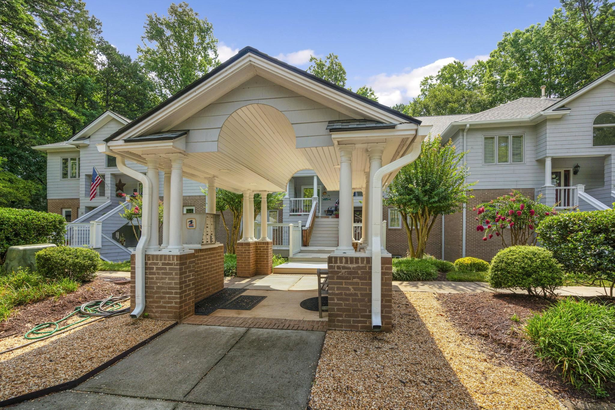 7500 Dartford Court, Unit 102 Raleigh, NC 27615 - Photo 2 of 36 a view of a house with a yard