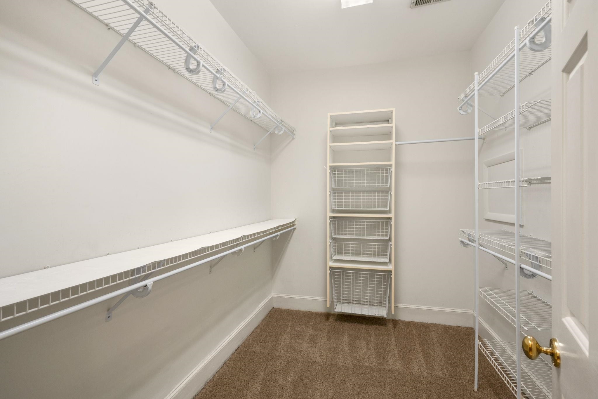 7500 Dartford Court, Unit 102 Raleigh, NC 27615 - Photo 24 of 36 a view of walk in closet with empty racks