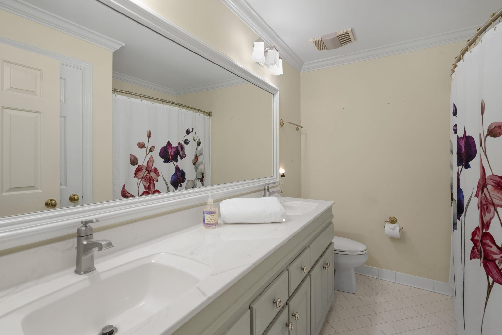 7500 Dartford Court, Unit 102 Raleigh, NC 27615 - Photo 27 of 36 a bathroom with a sink a toilet and a mirror