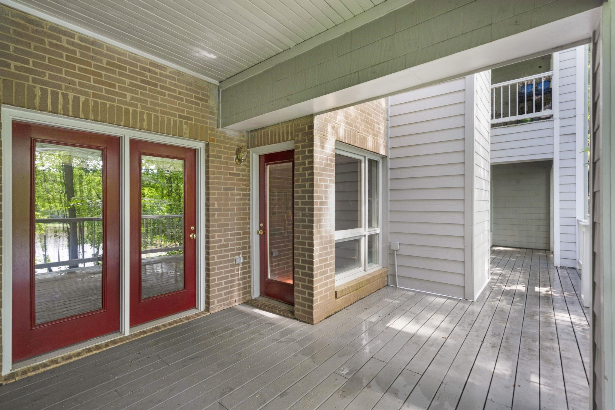 7500 Dartford Court, Unit 102 Raleigh, NC 27615 - Photo 30 of 36 a view of a porch with wooden floor and balcony