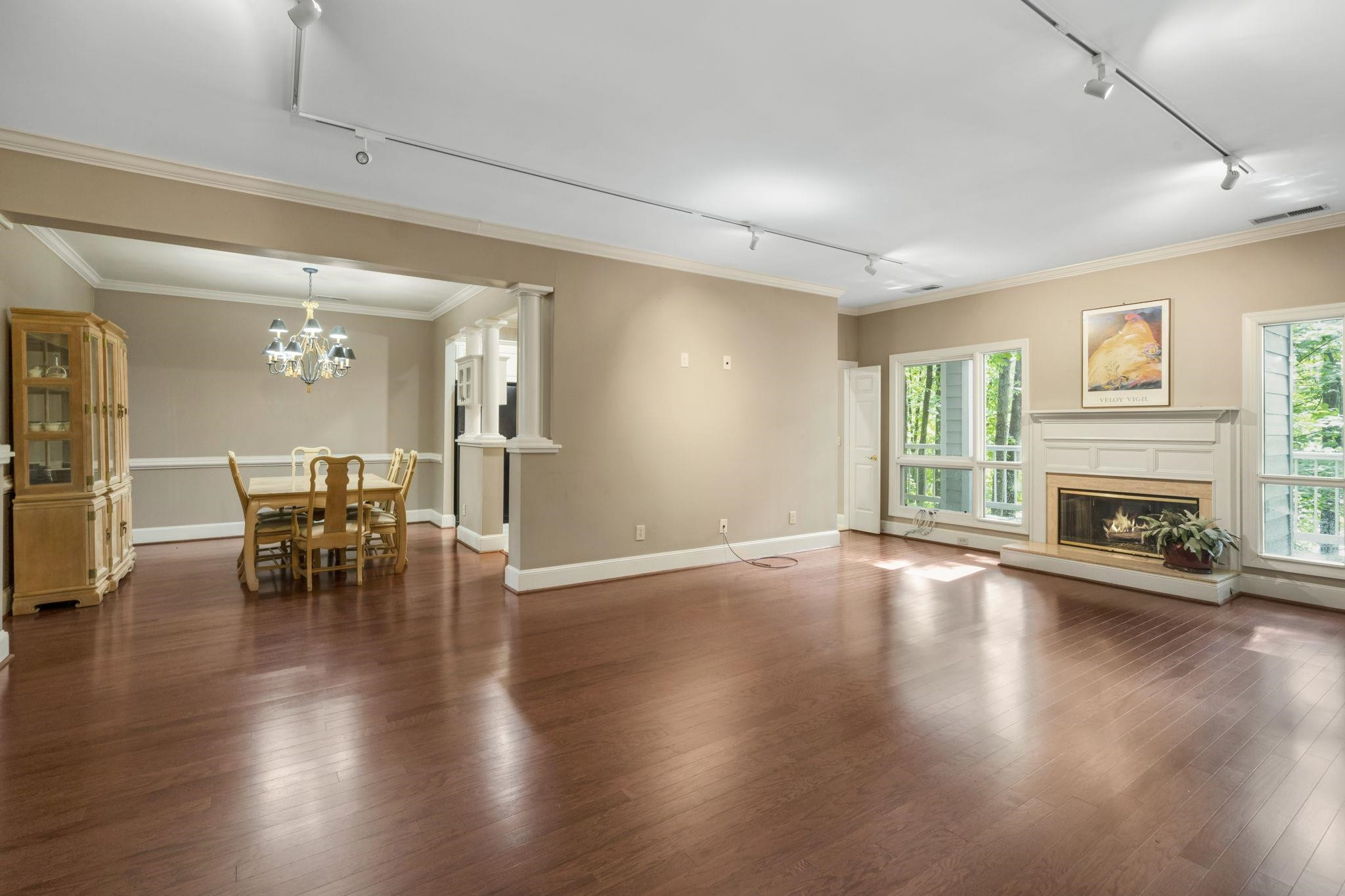 7500 Dartford Court, Unit 102 Raleigh, NC 27615 - Photo 4 of 36 a view of a livingroom with furniture a fireplace wooden floor and a window