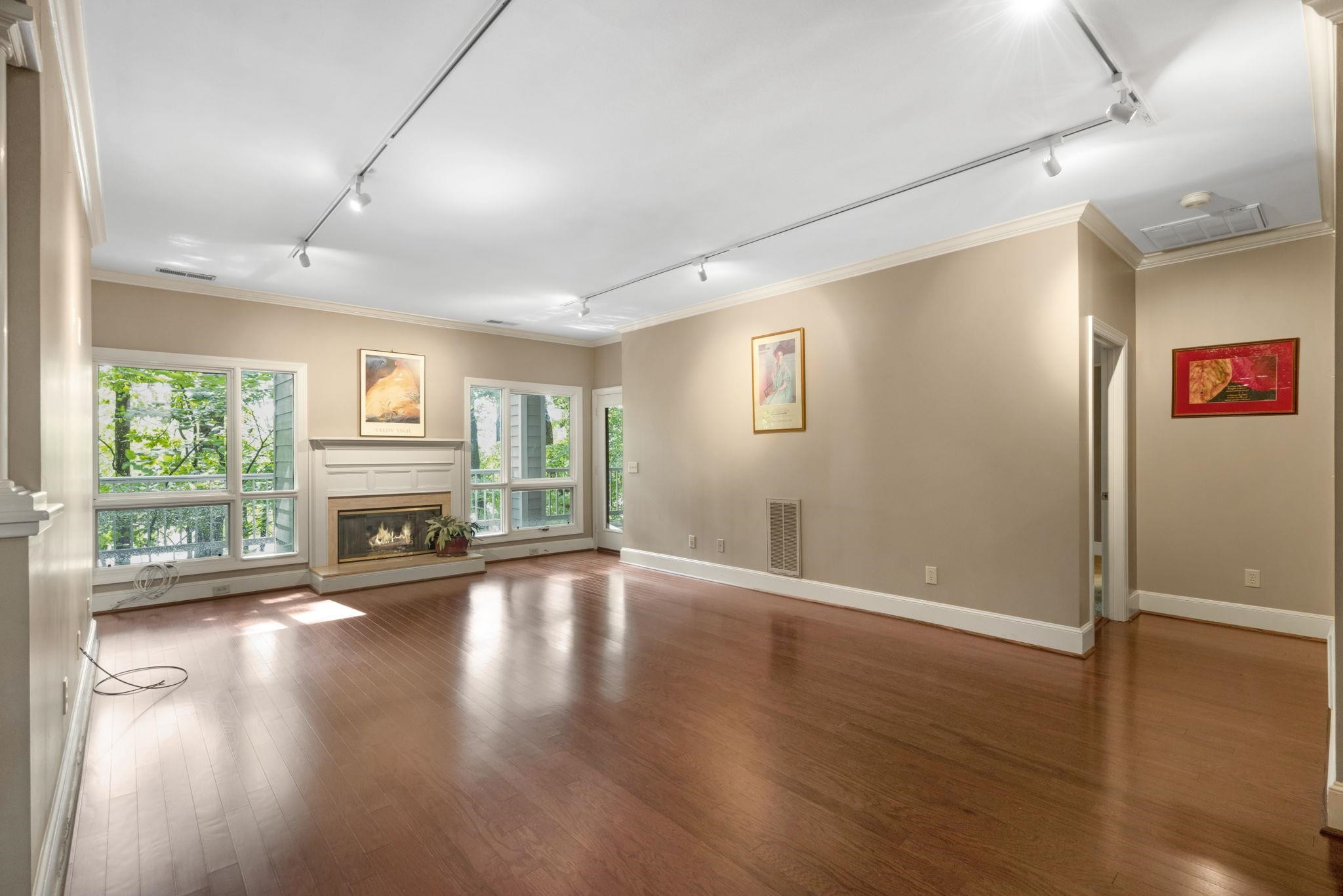 7500 Dartford Court, Unit 102 Raleigh, NC 27615 - Photo 7 of 36 wooden floor in an empty room with a window