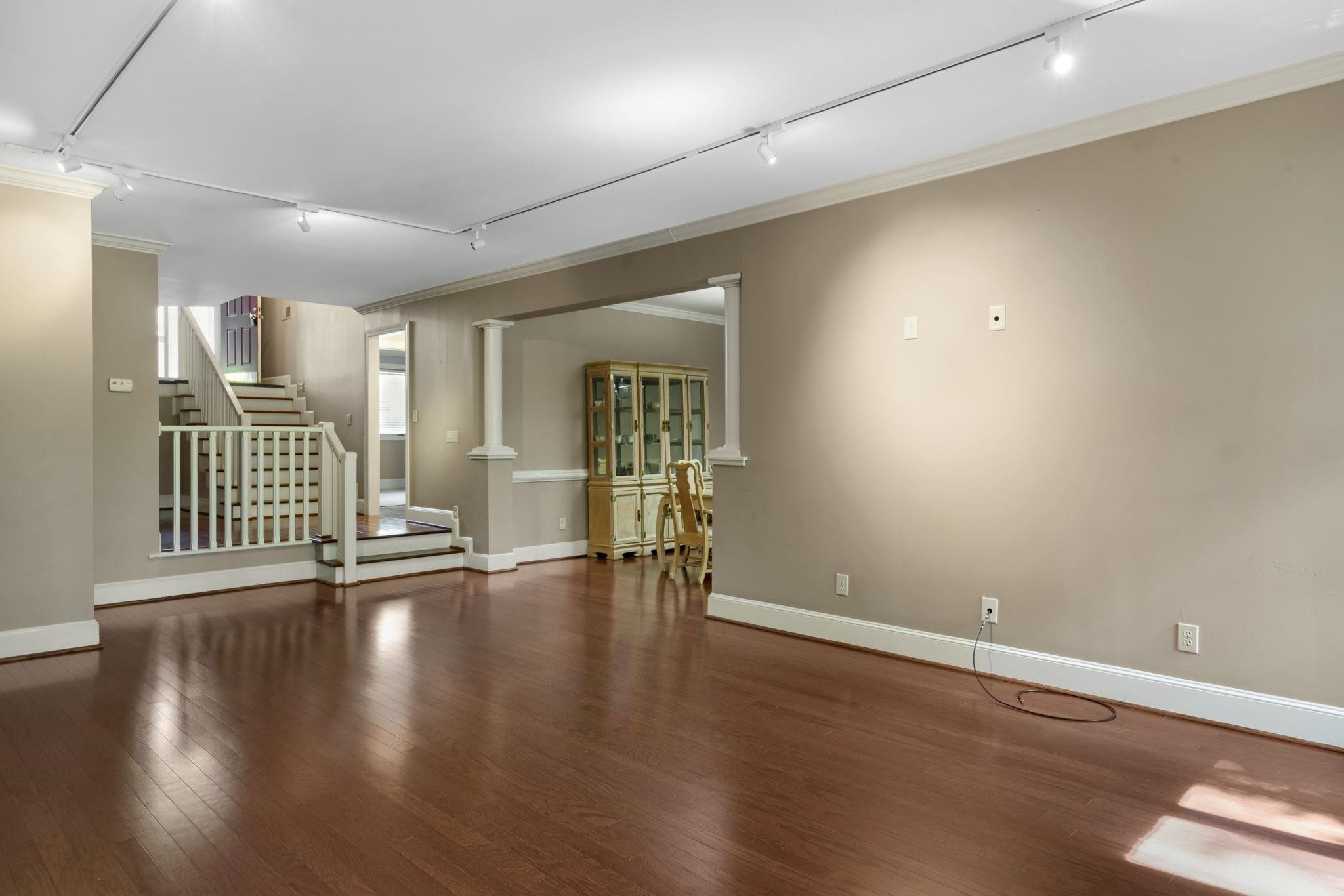 7500 Dartford Court, Unit 102 Raleigh, NC 27615 - Photo 8 of 36 an empty room with wooden floor and windows