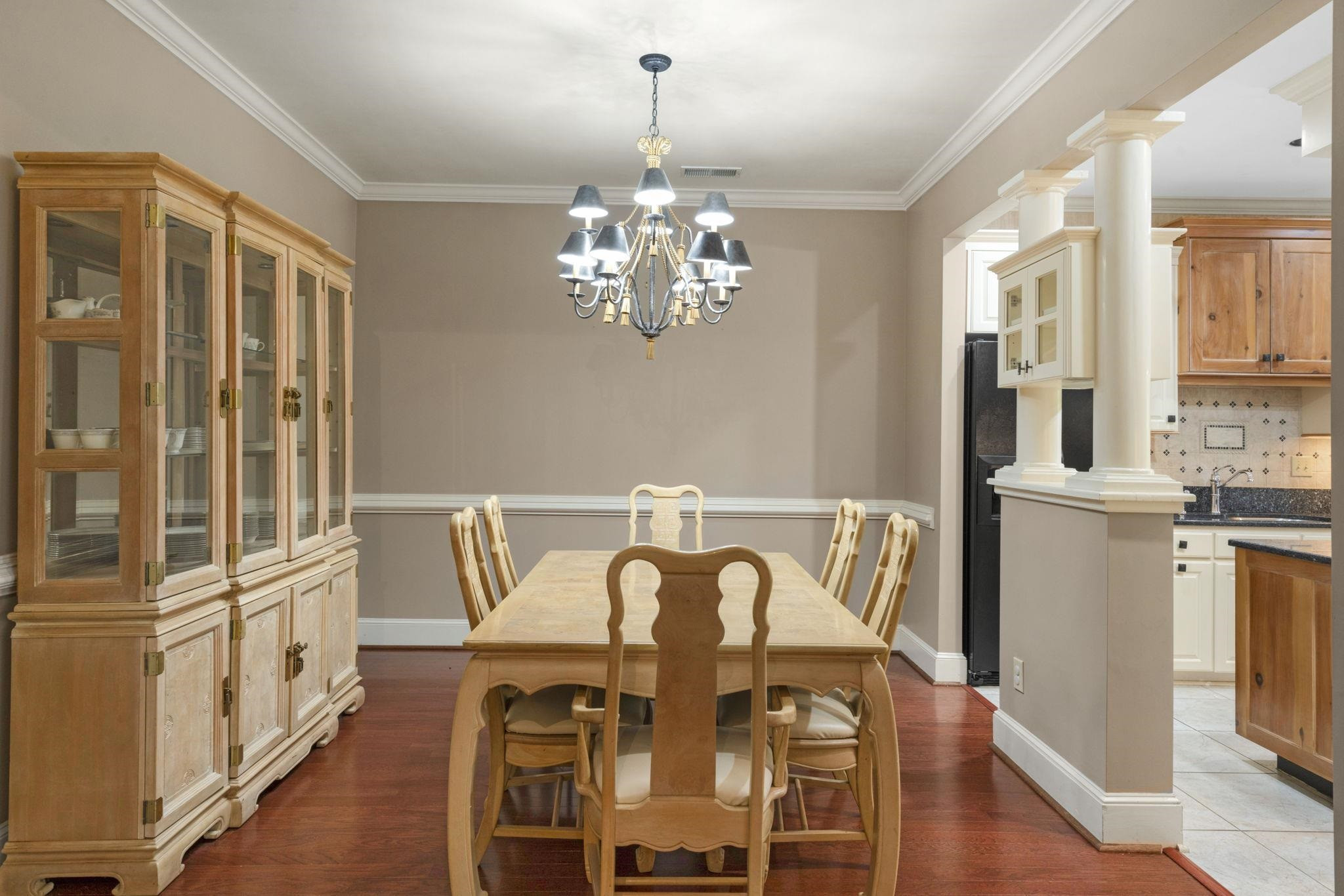 7500 Dartford Court, Unit 102 Raleigh, NC 27615 - Photo 9 of 36 a view of a dining room with furniture a chandelier and wooden floor
