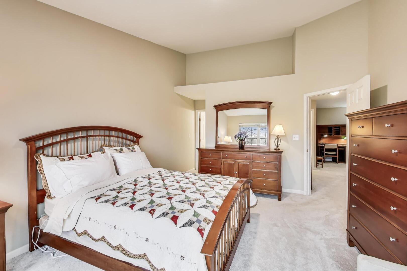 856 Old Checker Road Buffalo Grove, IL 60089 - Photo 19 of 31 a bedroom with a large bed and a dresser