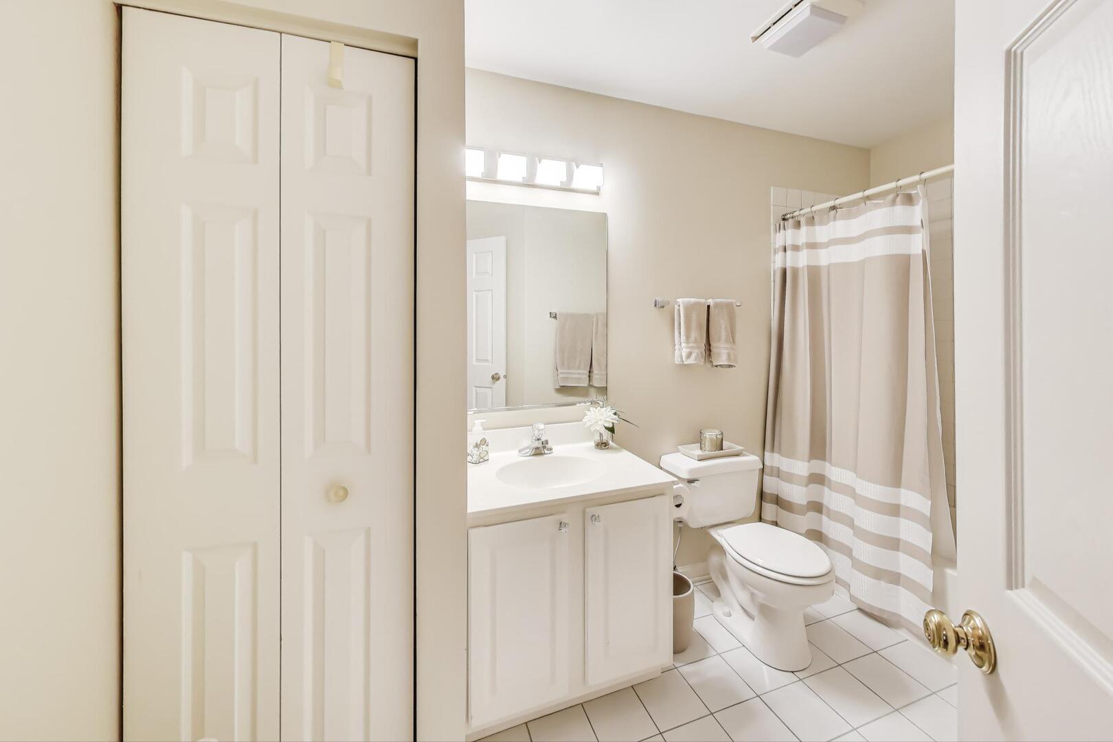 856 Old Checker Road Buffalo Grove, IL 60089 - Photo 23 of 31 a bathroom with a toilet a sink and a mirror