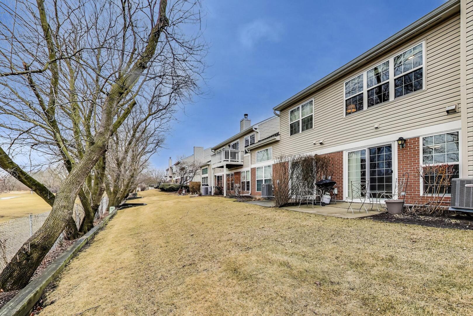 856 Old Checker Road Buffalo Grove, IL 60089 - Photo 28 of 31 a view of a house with a yard covered in snow