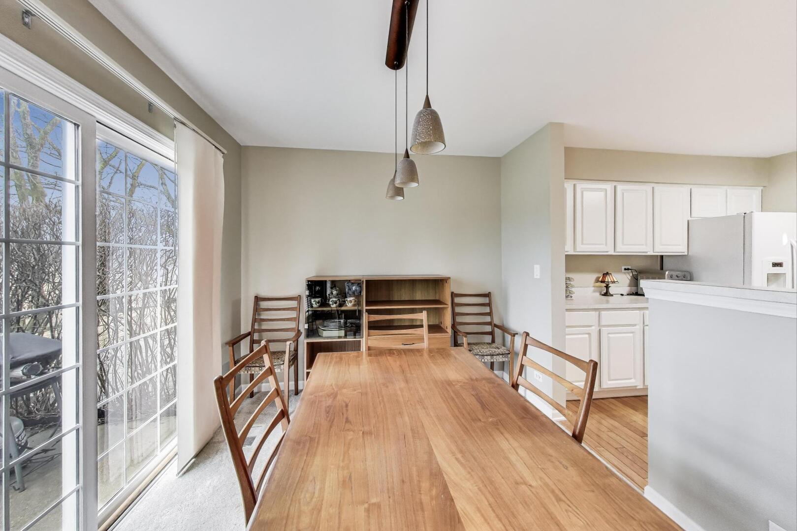 856 Old Checker Road Buffalo Grove, IL 60089 - Photo 8 of 31 a view of a kitchen with kitchen island and wooden floor
