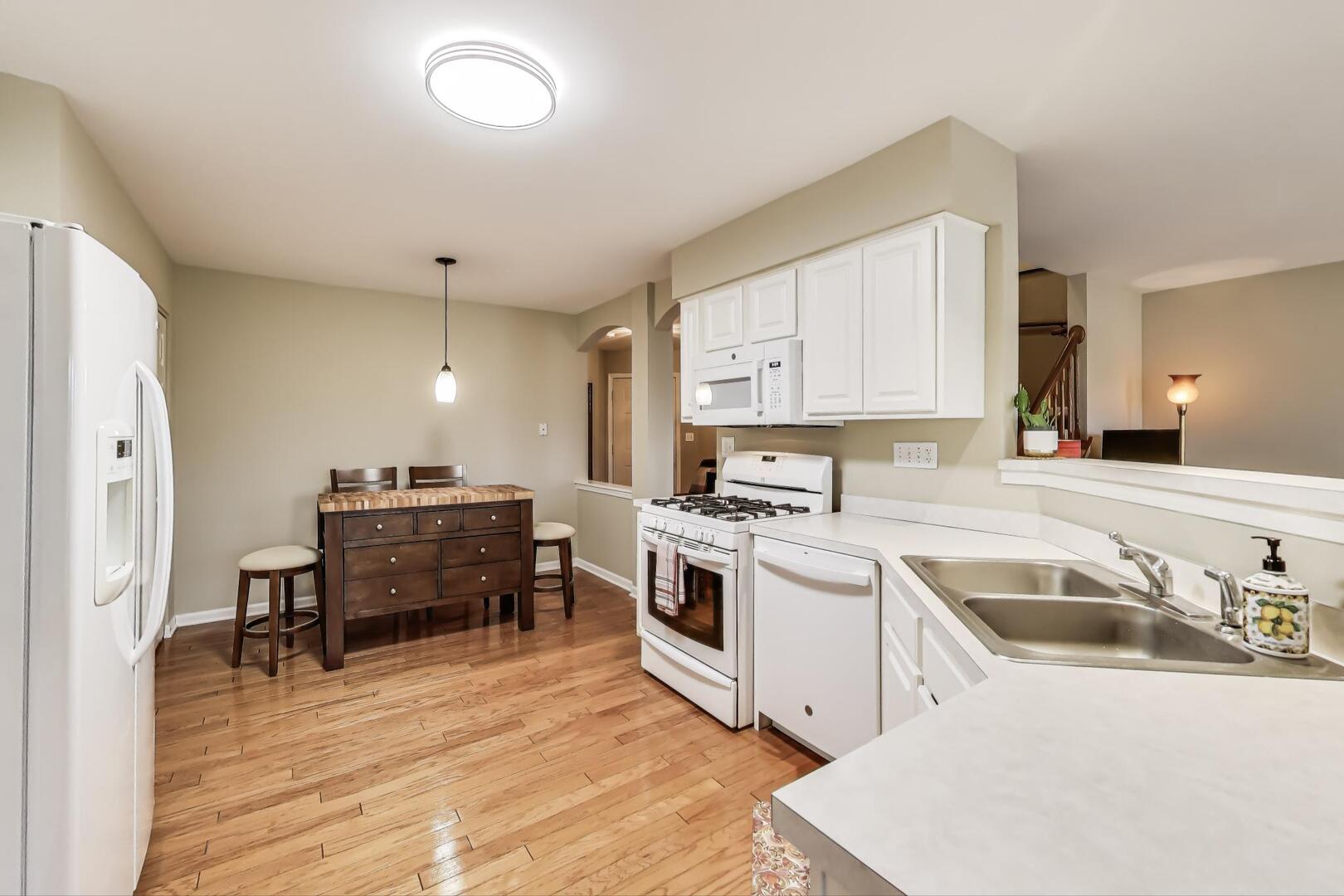 856 Old Checker Road Buffalo Grove, IL 60089 - Photo 10 of 31 a kitchen with a sink appliances and cabinets