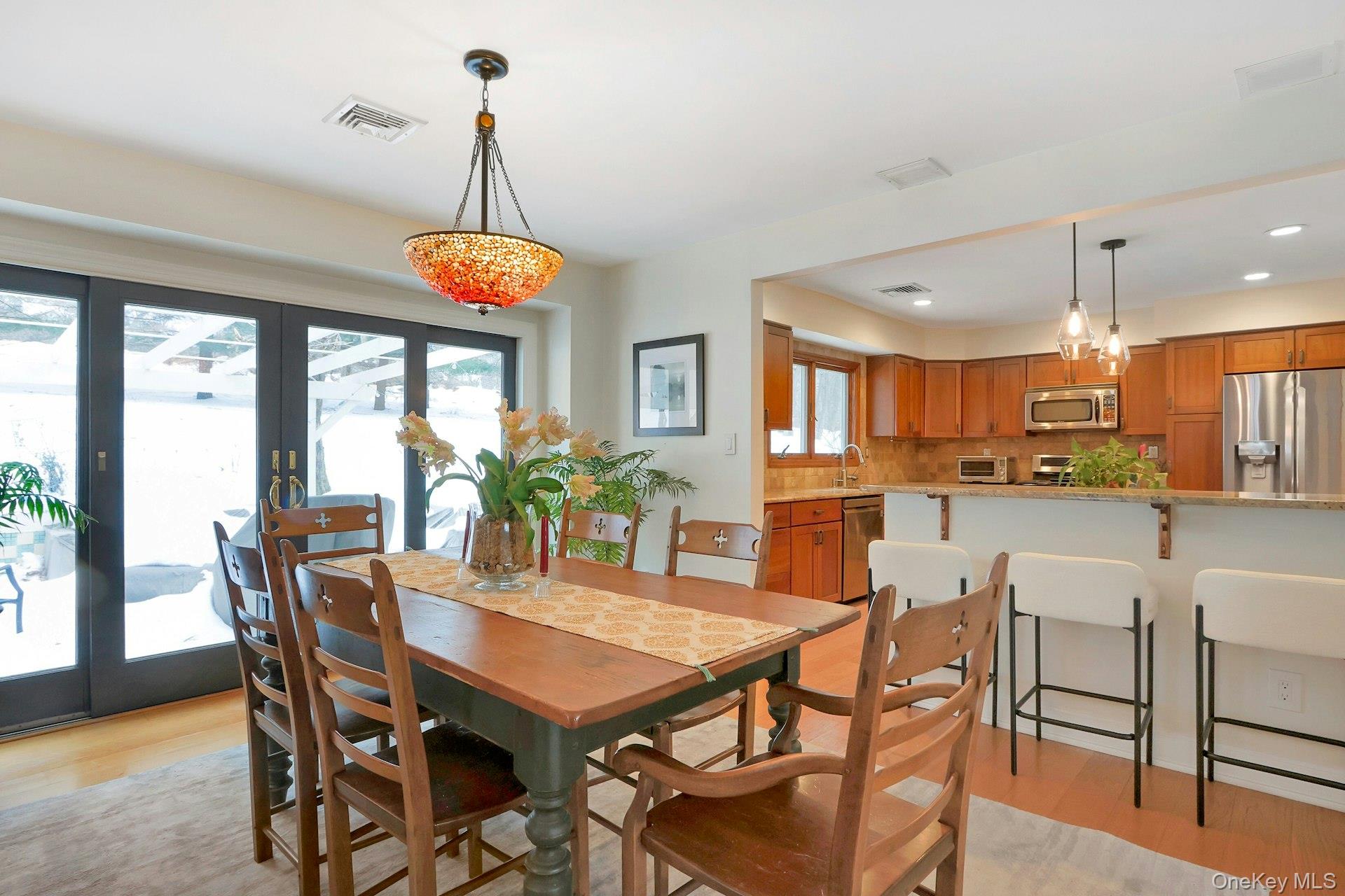 111 Wydendown Road Nyack, NY 10960 - Photo 13 of 46 a view of a dining room and livingroom with furniture wooden floor a chandelier
