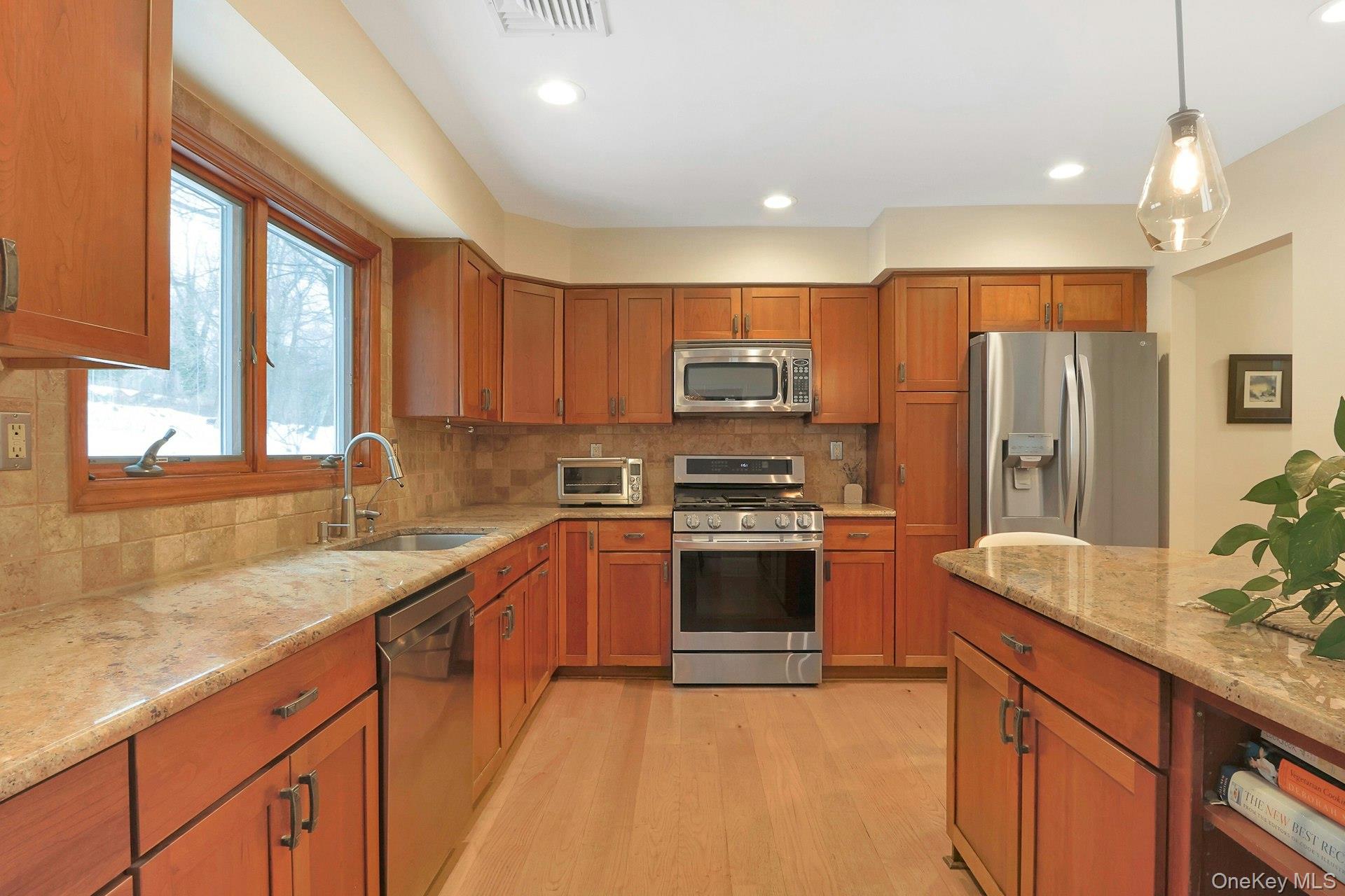 111 Wydendown Road Nyack, NY 10960 - Photo 15 of 46 a kitchen with stainless steel appliances granite countertop a sink stove and refrigerator