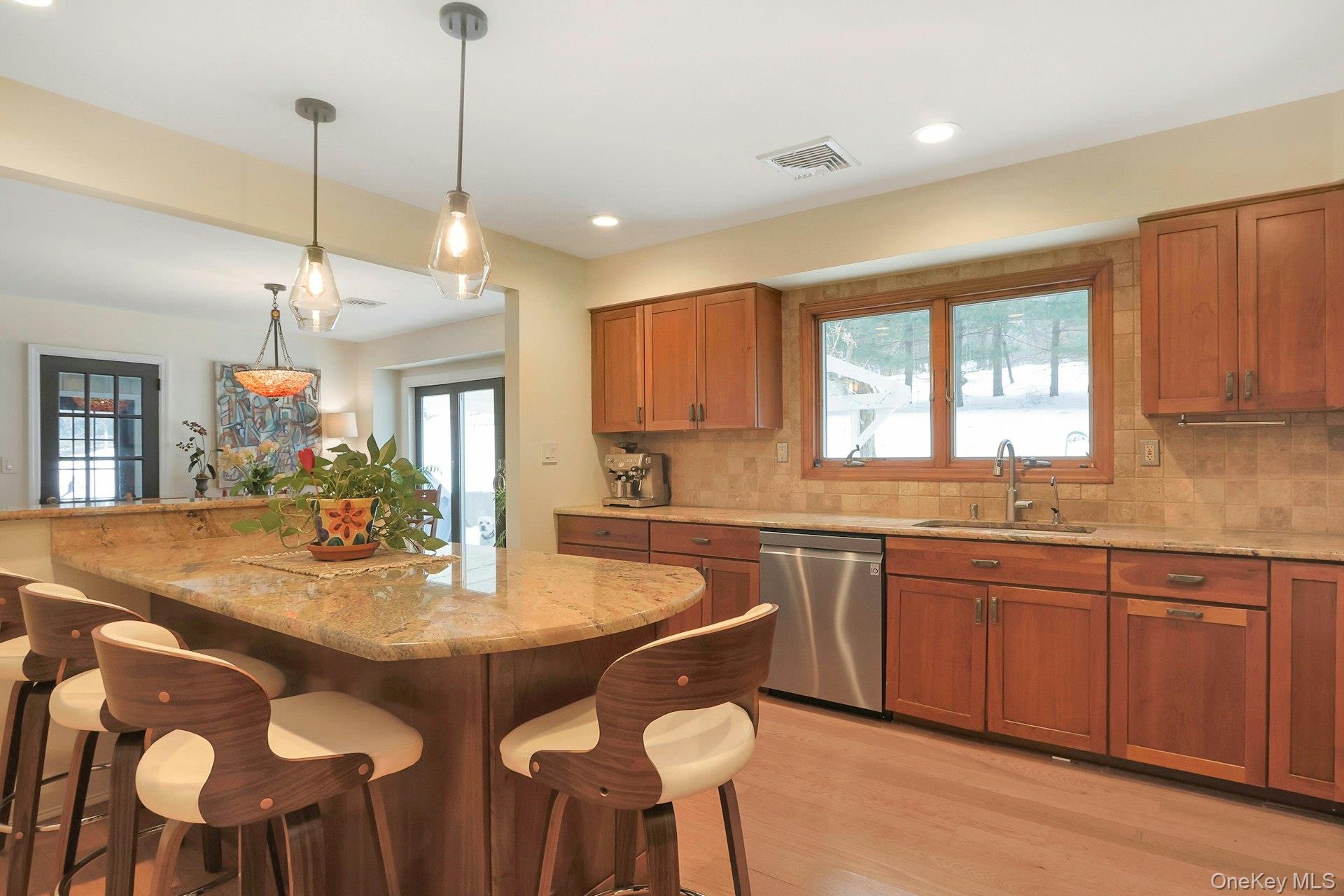 111 Wydendown Road Nyack, NY 10960 - Photo 16 of 46 a kitchen with stainless steel appliances granite countertop a dining table chairs and white cabinets