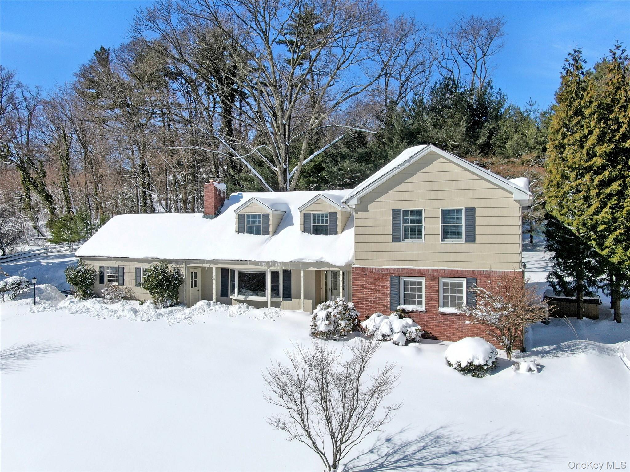 111 Wydendown Road Nyack, NY 10960 - Photo 3 of 46 a front view of a house with a yard covered in snow