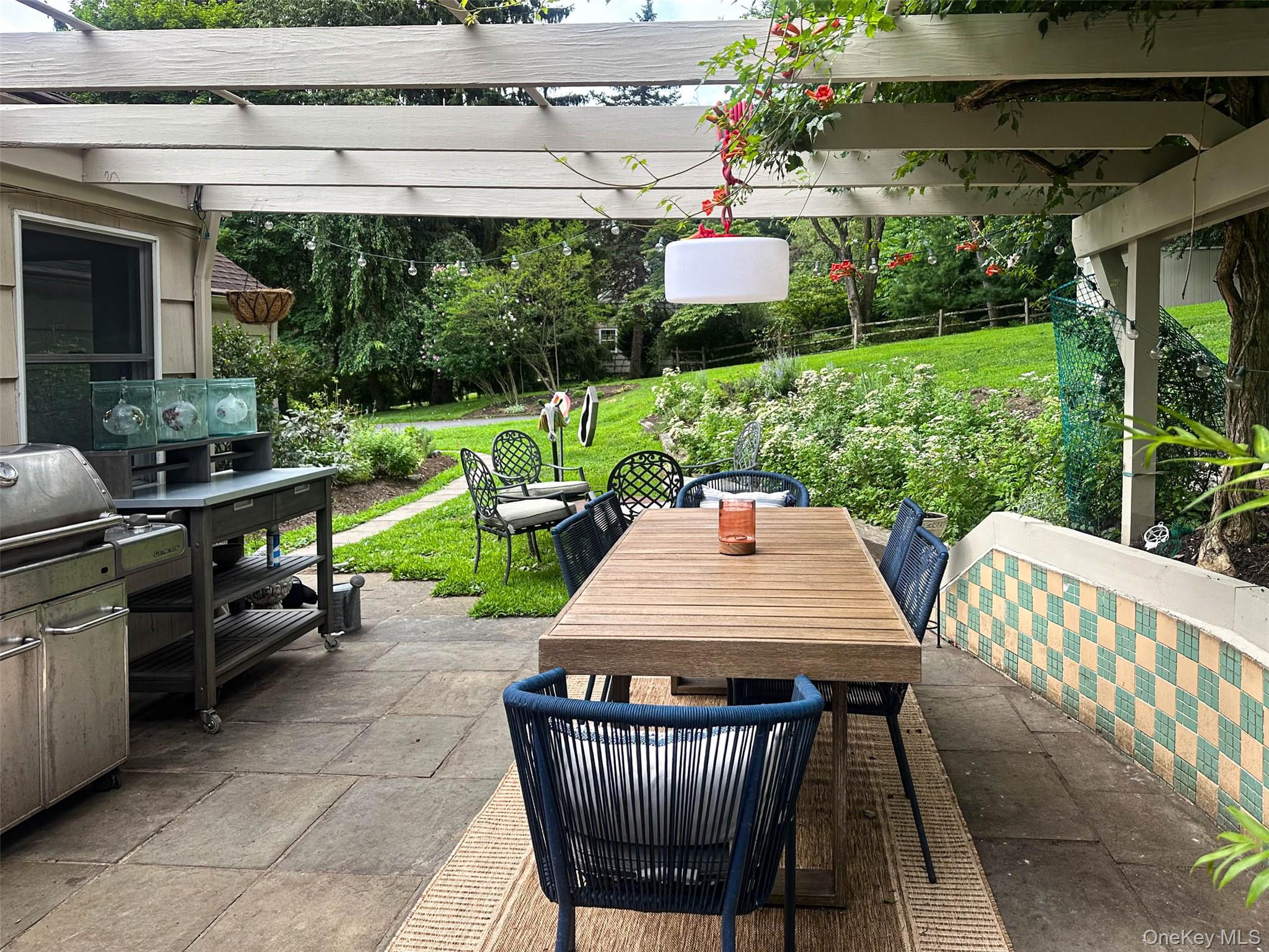 111 Wydendown Road Nyack, NY 10960 - Photo 39 of 46 a view of a patio with a table chairs and a yard
