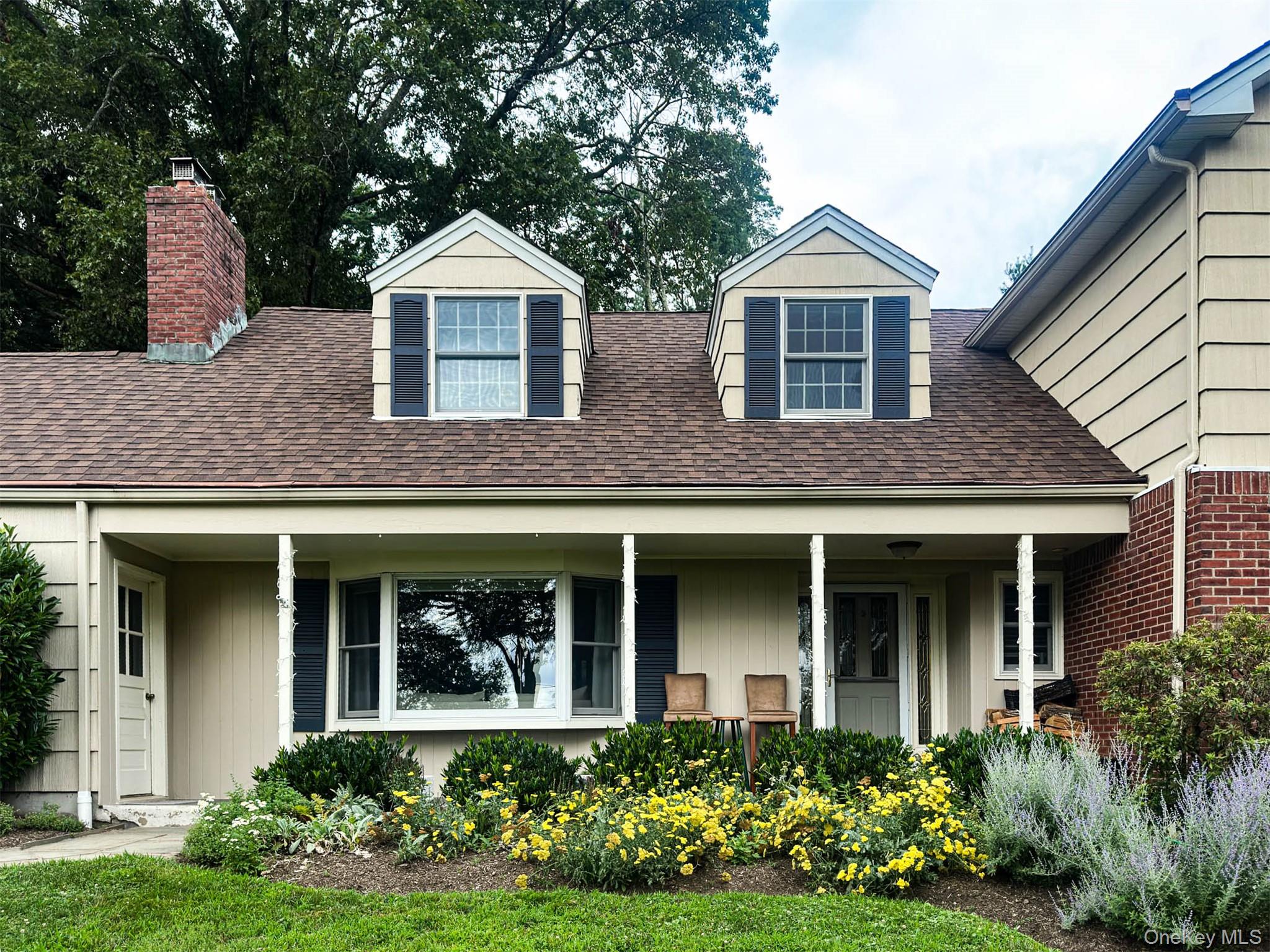 111 Wydendown Road Nyack, NY 10960 - Photo 42 of 46 a front view of a house with a yard and potted plants