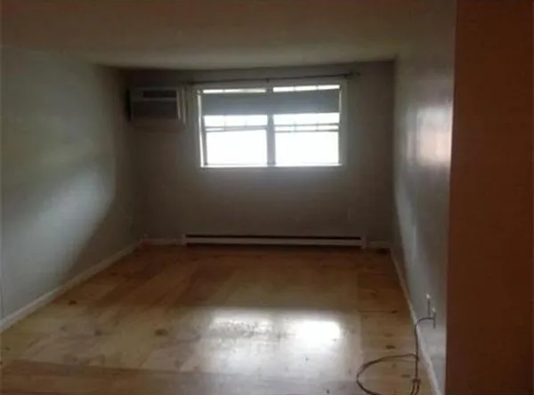 a view of a room with window and wooden floor