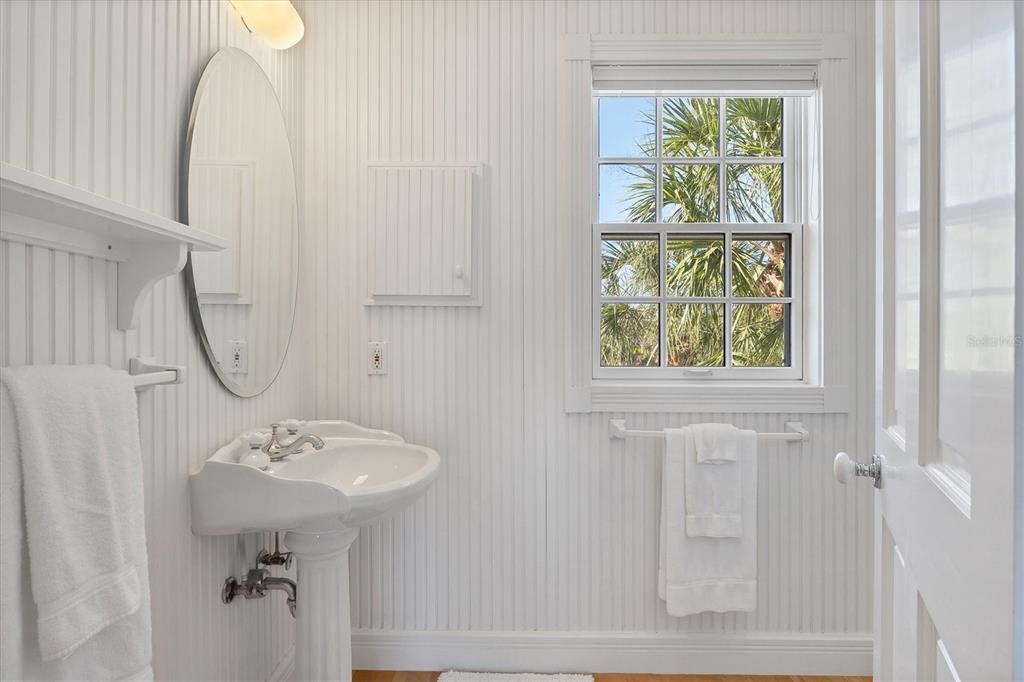 208 Harbor Drive Boca Grande, FL 33921 - Photo 18 of 53 a bathroom with a sink a mirror and a window