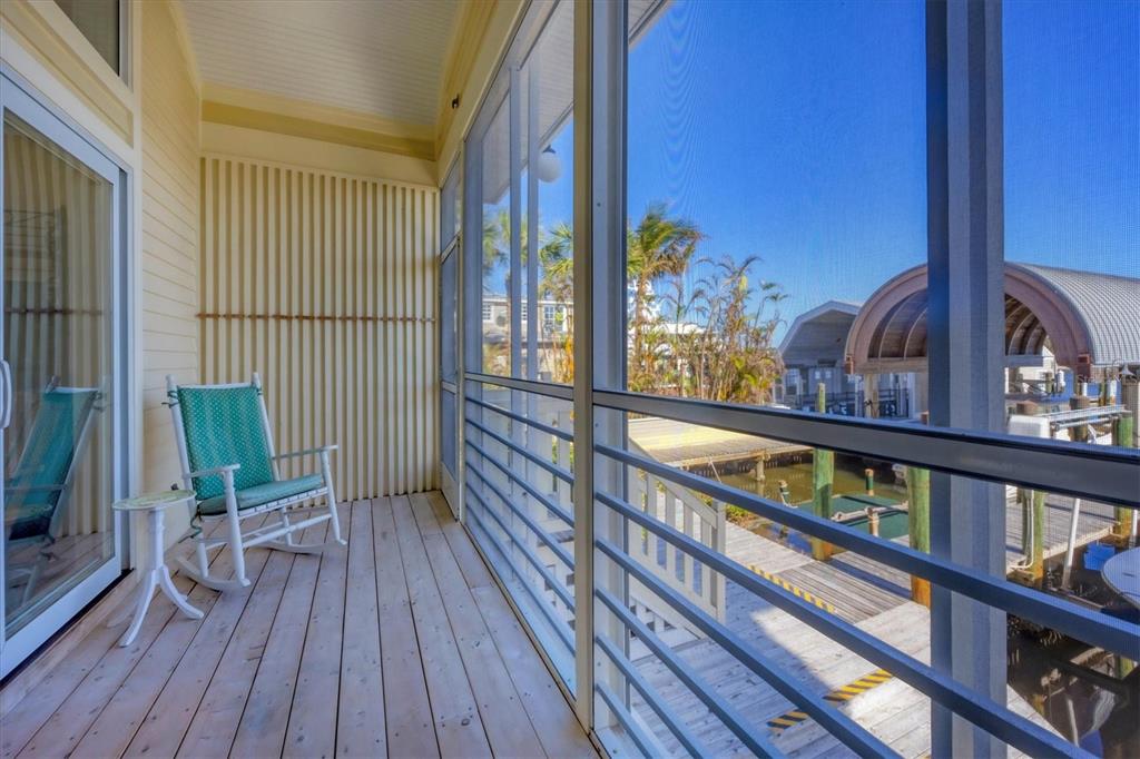 208 Harbor Drive Boca Grande, FL 33921 - Photo 25 of 53 a balcony with wooden floor