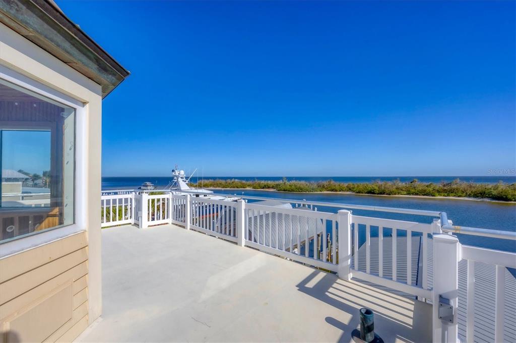 208 Harbor Drive Boca Grande, FL 33921 - Photo 35 of 53 a view of a balcony with wooden floor and a city view