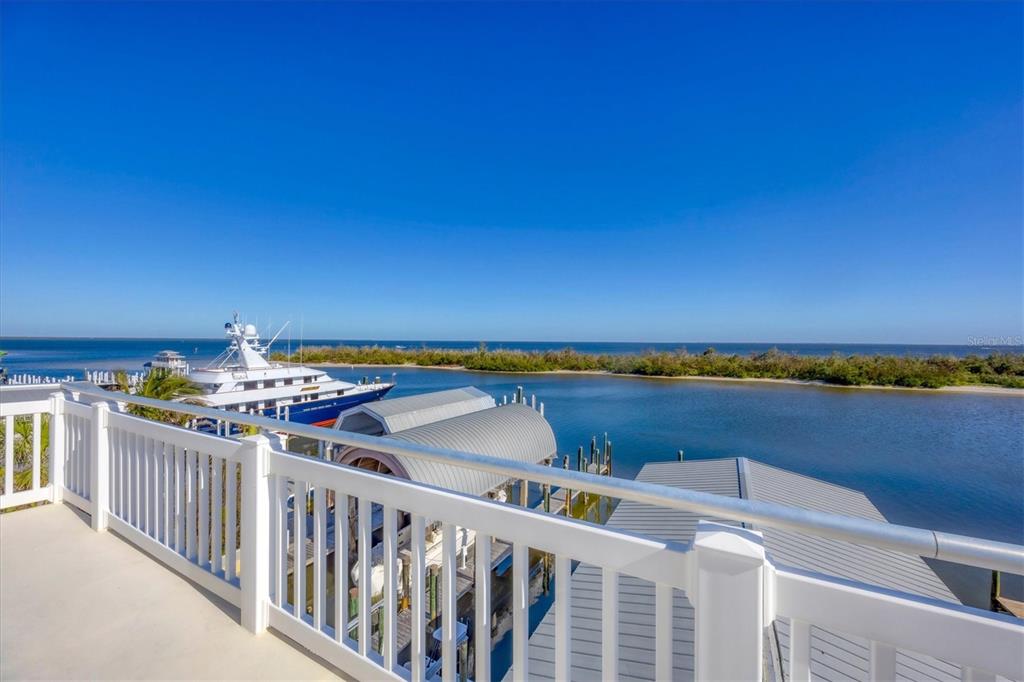 208 Harbor Drive Boca Grande, FL 33921 - Photo 36 of 53 a view of a balcony with wooden floor and city view