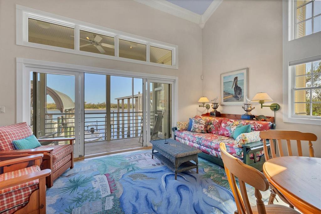 208 Harbor Drive Boca Grande, FL 33921 - Photo 8 of 53 a living room filled with furniture and a floor to ceiling window