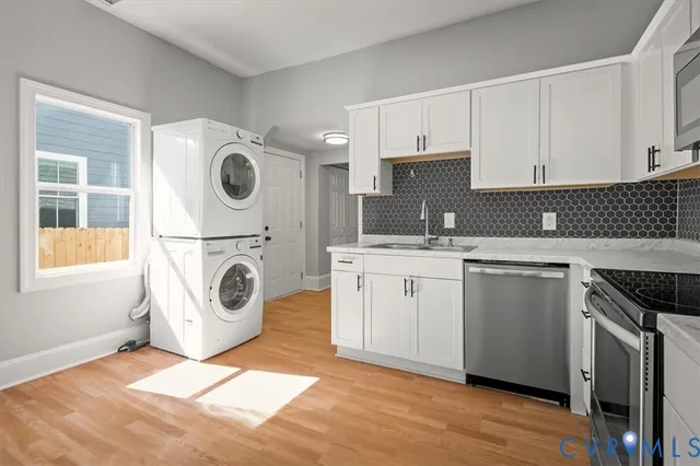 a view of a hallway with washer and dryer
