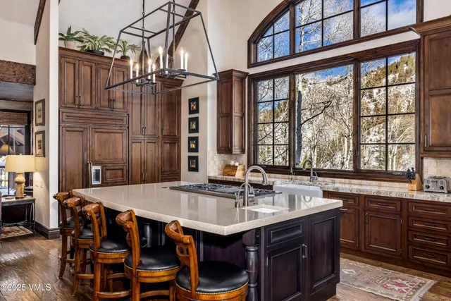 a living room with furniture a table and a large window