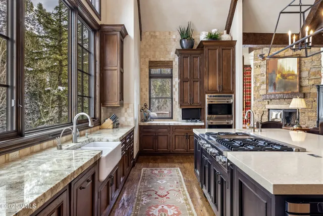 a living room with furniture fireplace and a large window