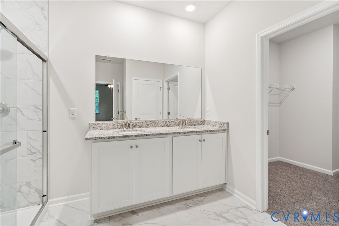 7614 Patriots Way Gloucester, VA 23061 - Photo 31 of 32 a bathroom with a granite countertop sink and a mirror