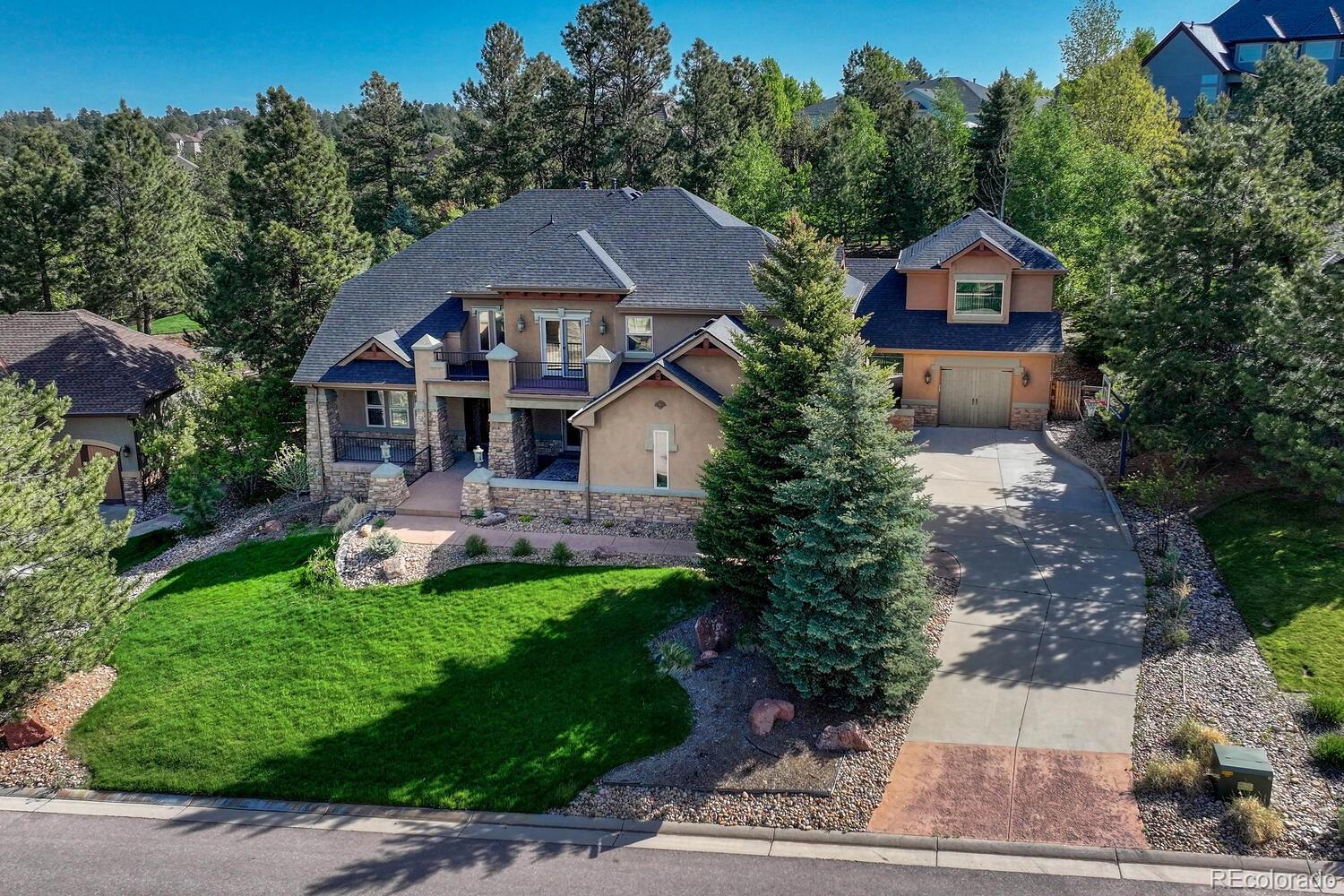 a aerial view of a house with a big yard plants and large trees