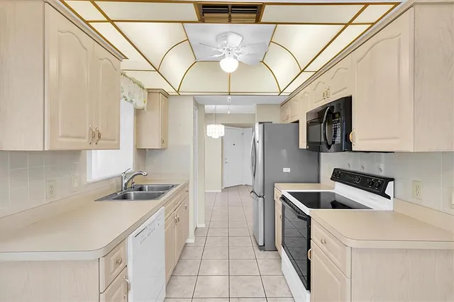 a kitchen with stainless steel appliances a refrigerator stove and microwave