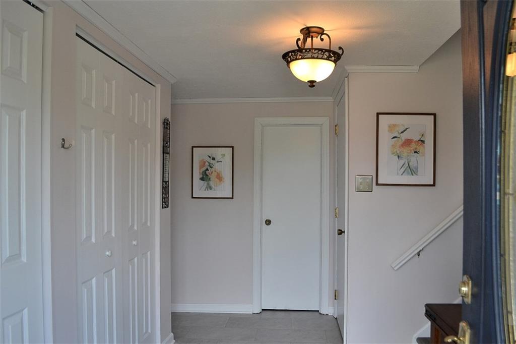 Entry.  The bright entry is certainly welcoming!  There is new flooring here, two large, double closets, the powder room, and easy access to the Family Room (right around the bend), or up the steps to the main living area.