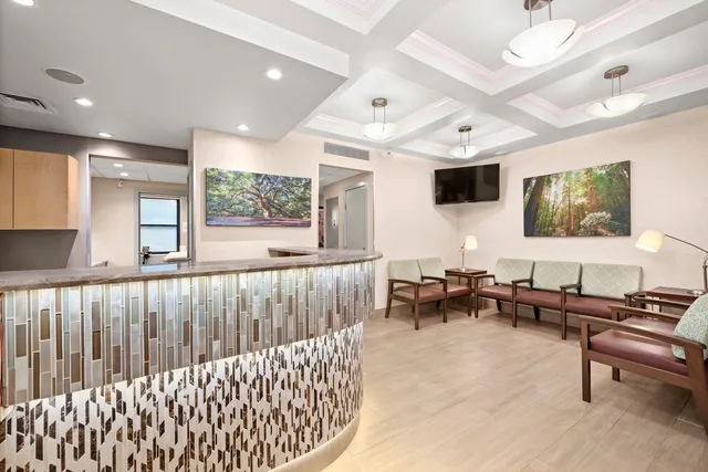 a living room with furniture tv and a window