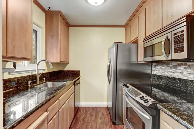 a kitchen with a refrigerator stove and microwave