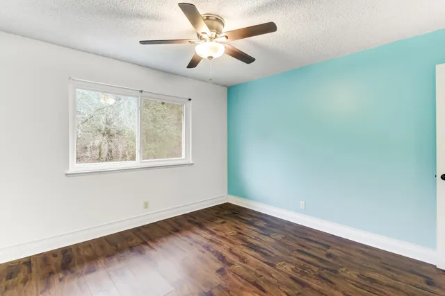 a bathroom with a granite countertop sink a toilet and shower