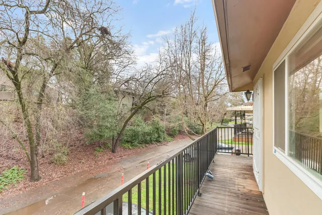 a view of a balcony with wooden fence and floor