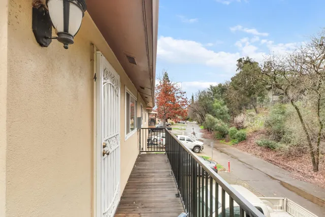 a view of a balcony with wooden floor