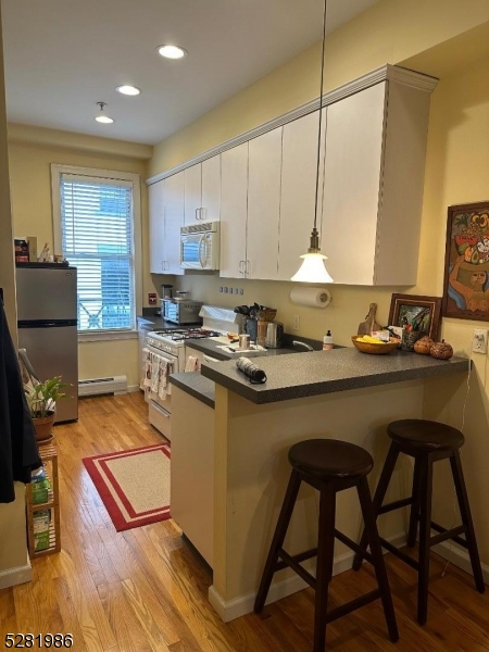a kitchen with a table chairs stove and cabinets
