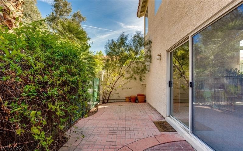 5272 Island Chain Road Las Vegas, NV 89118 - Photo 6 of 31 An inviting brick patio provides an outdoor retreat, perfectly framed by lush privacy plantings.